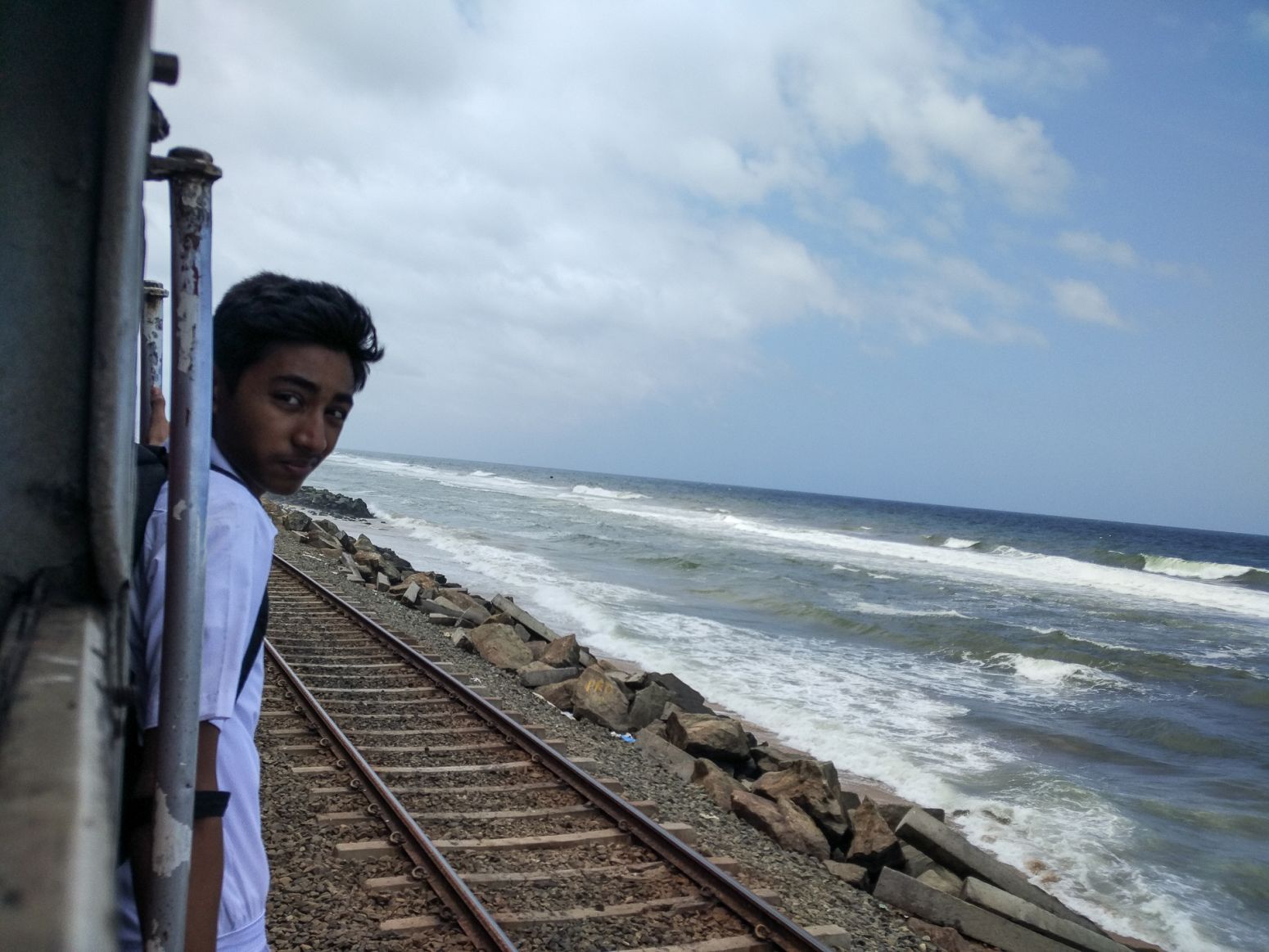 A boy travelling on the train between Colombo and Galle, Sri Lanka